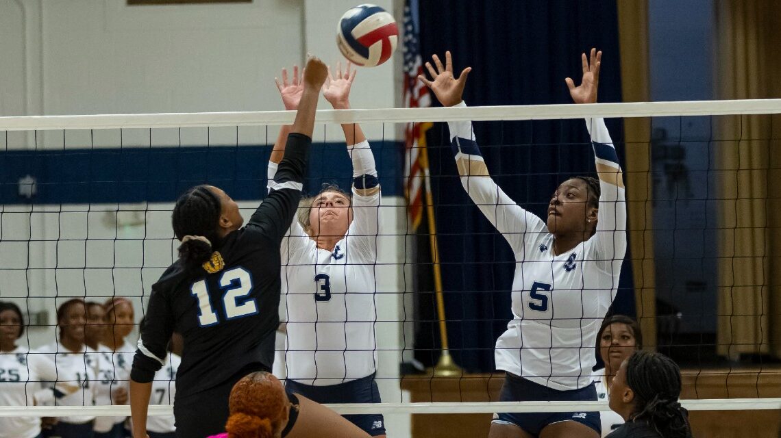 Katelynn Madison and Aeraeonna Manuel attempt a block against Oakwood. (Photo by David Miller)