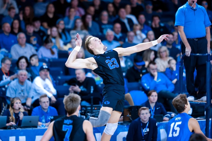 Luke Benson attacks for BYU in the Cougars' NCAA men's volleyball match against Ball State in Provo, Utah