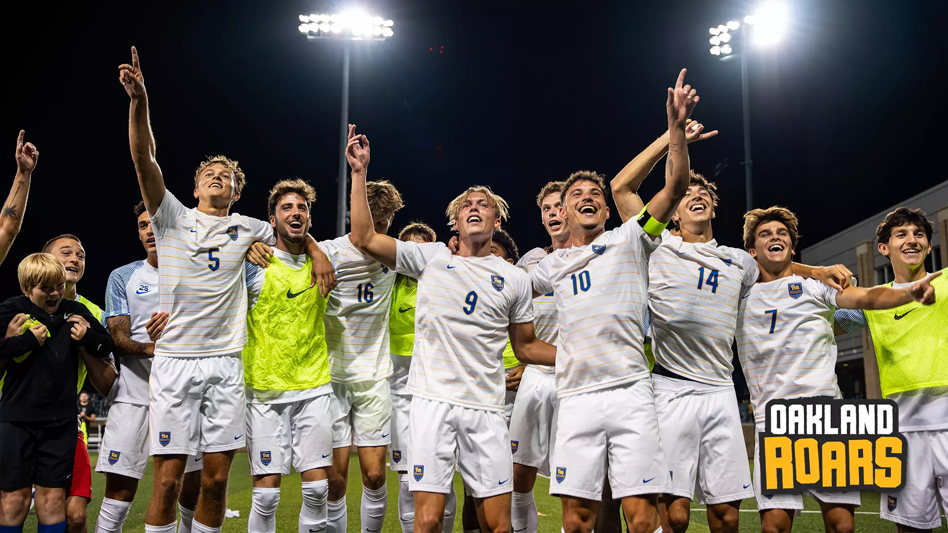 The Pitt Men's Soccer team celebrating on the field after a win